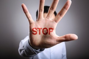 An open hand with the word STOP written on it