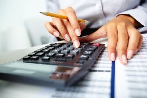 Close-up of hands and calculator