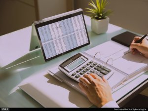 man with computer and calculator