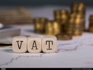 blocks with the inscription VAT, coins in the background