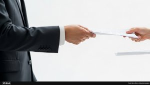 people passing a document to each other