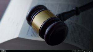 judge's gavel lying on an open book
