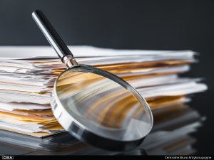 A magnifying glass and documentation on the table.