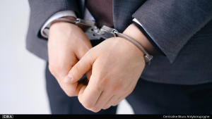 Close-up of handcuffed hands.