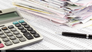 Calculator and documents lying on the table.