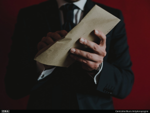 A man holding an envelope.
